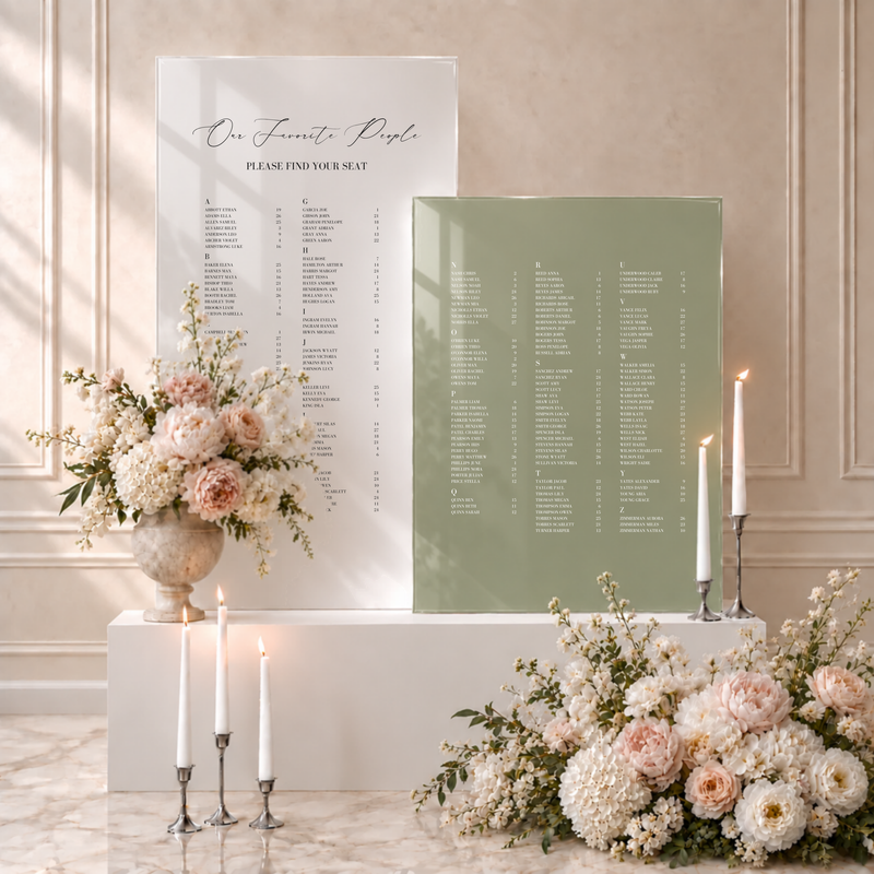 Aria acrylic double wedding seating chart: alphabetical guest list with table numbers across a white acrylic panel and a sage green acrylic panel, styled with flowers and candles