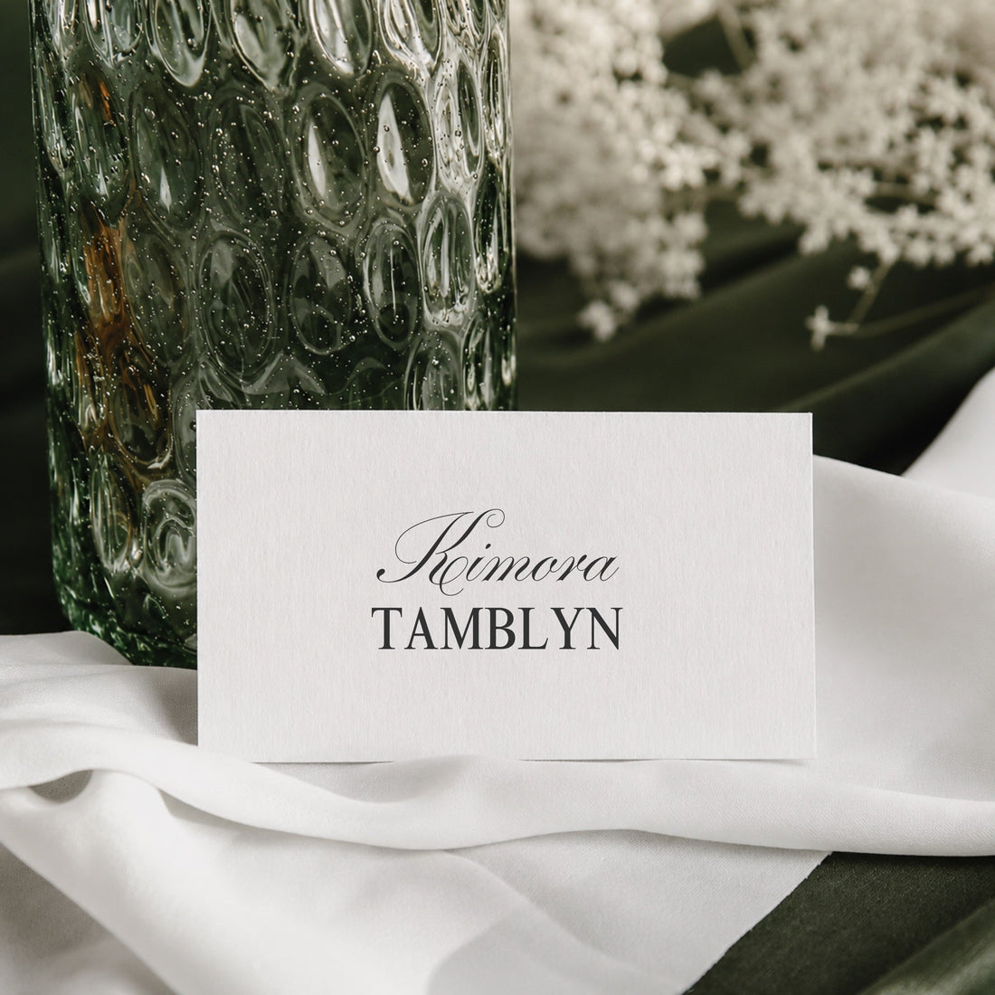 Juliette printable wedding place card template beside a green glass vase