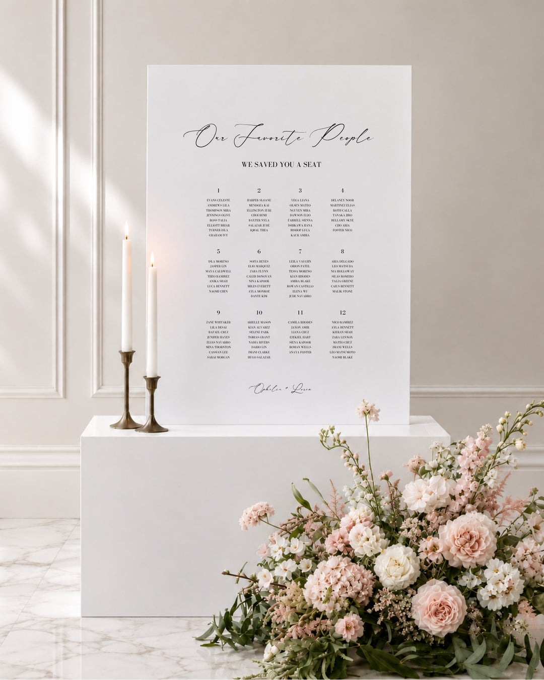 Aria acrylic wedding seating chart on a white plinth with taper candles and blush florals