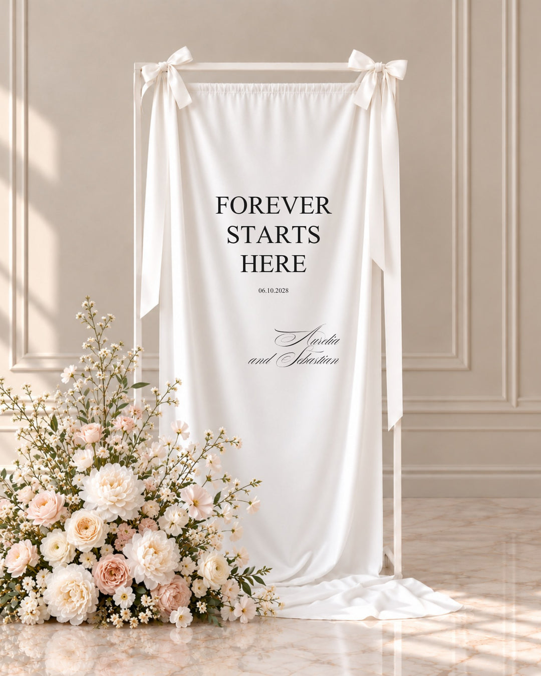 Florence fabric wedding welcome sign hanging from a white stand beside blush and ivory florals