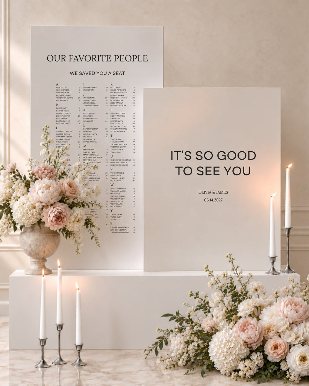 Moda acrylic wedding welcome sign and seating chart pair on white plinths with taper candles and blush florals