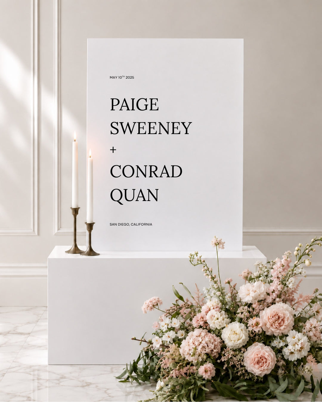 Moda acrylic wedding welcome sign on a white plinth with taper candles and blush florals