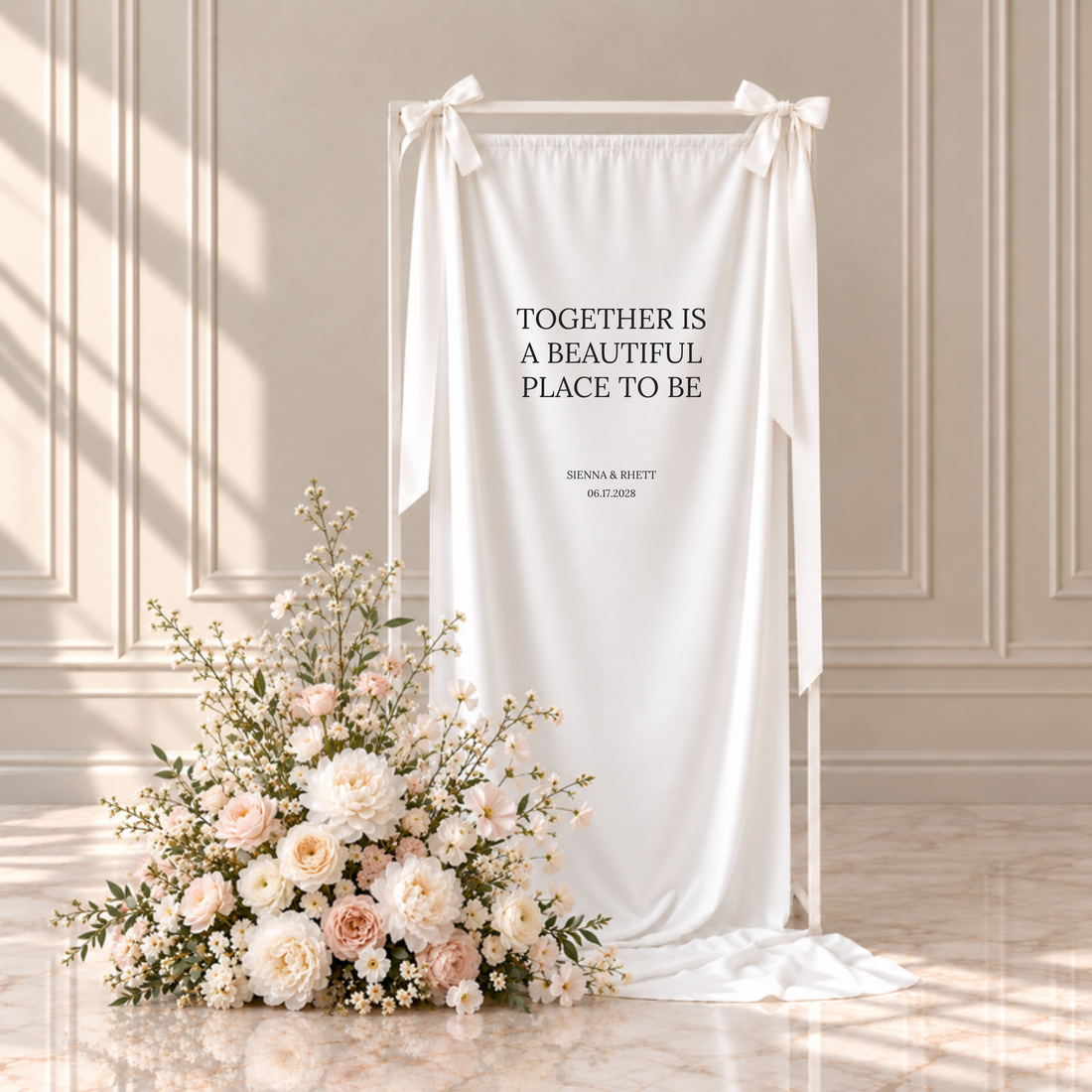 Moda fabric custom quote wedding sign: together is a beautiful place to be, with the couple's names and wedding date, hanging from a white frame with ribbon bows beside blush and ivory flowers