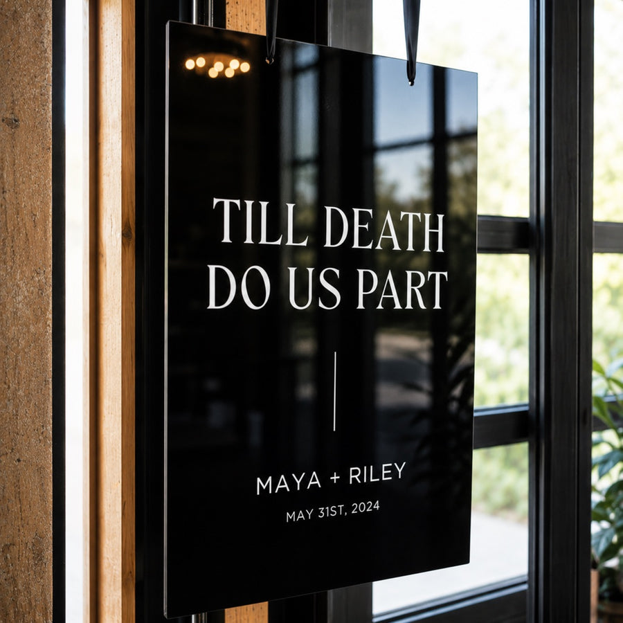 Black acrylic Till Death Do Us Part sign hanging in a window